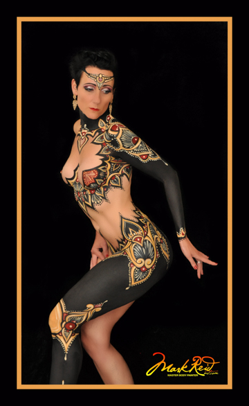 Woman body painted with gold and matte blacks resembling leather